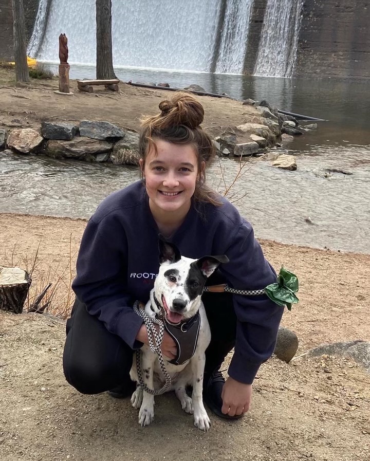 Annika Williams outside kneeling by her dog