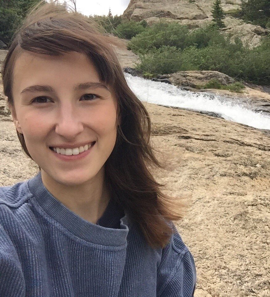 Catherine “Kate” Hackim in front of a rocky creek