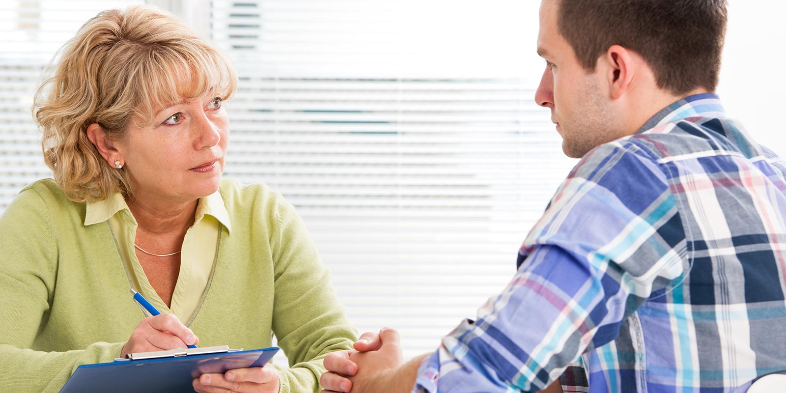 man and woman at a table talking