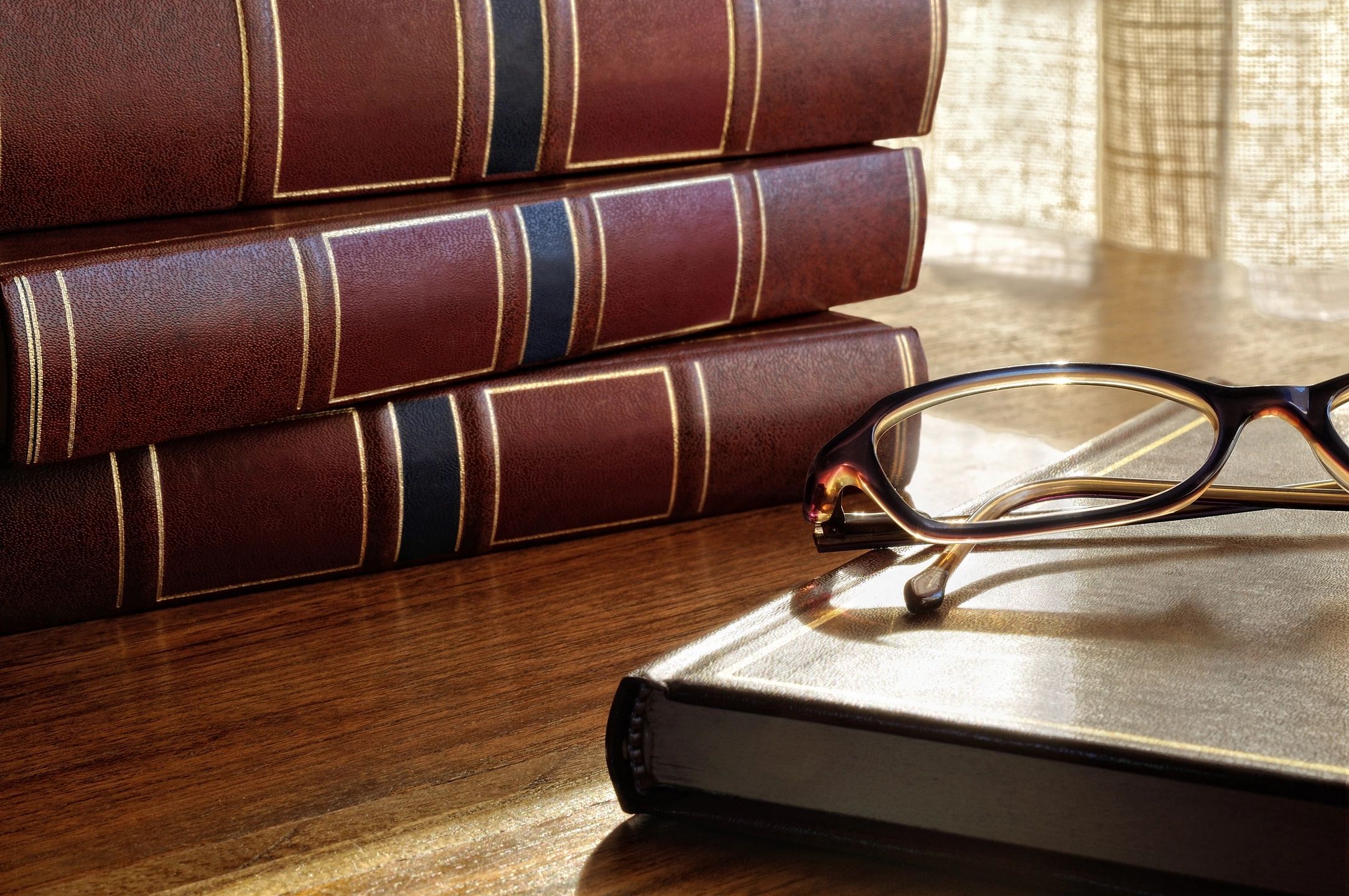 law books and glasses on a desk